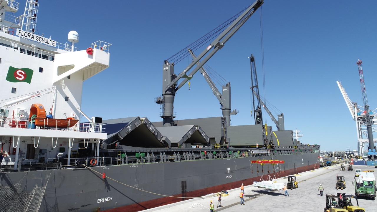 Breakbulk lumber is offloaded via crane from a vessel secured at a Port Canaveral's cargo berth.