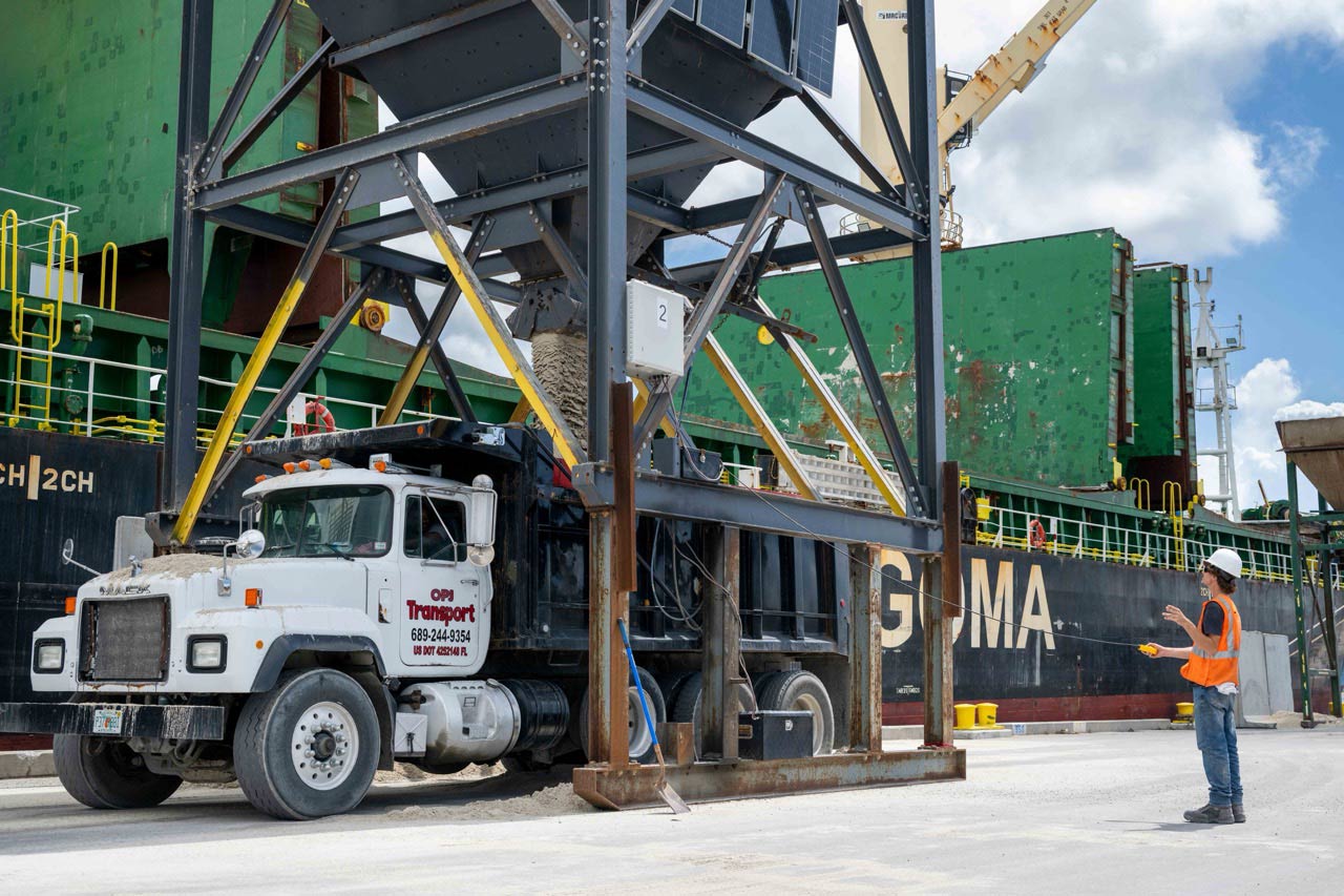 Sand is discharged via a hopper into a truck at Port Canaveral.