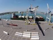 Picture1 A large container ship is securely docked at a bustling port, ready for loading and unloading operations.