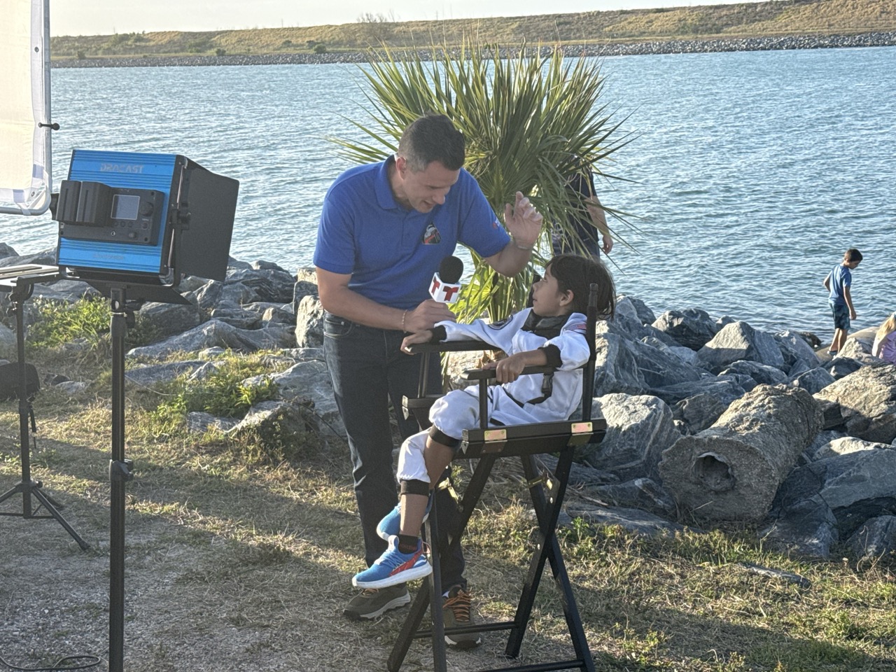 AyounggirlinanastronautcostumeisinterviewedatJettyPark